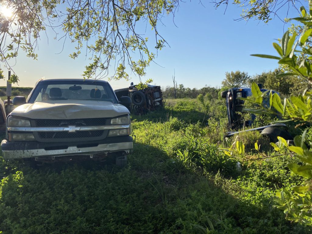 Cars destroyed by past hurricanes decorate Tamplet's yard.